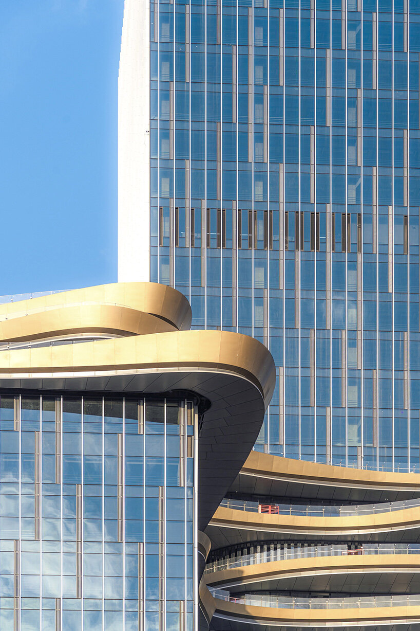 golden sky bridge by aedas stitches together towers with its looping shape in china