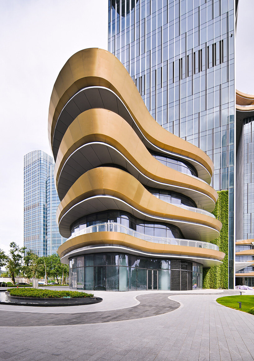 golden sky bridge by aedas stitches together towers with its looping shape in china