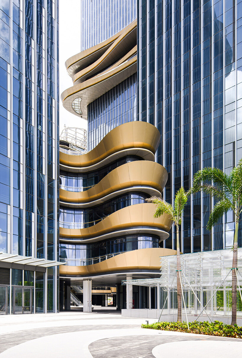 golden sky bridge by aedas stitches together towers with its looping shape in china
