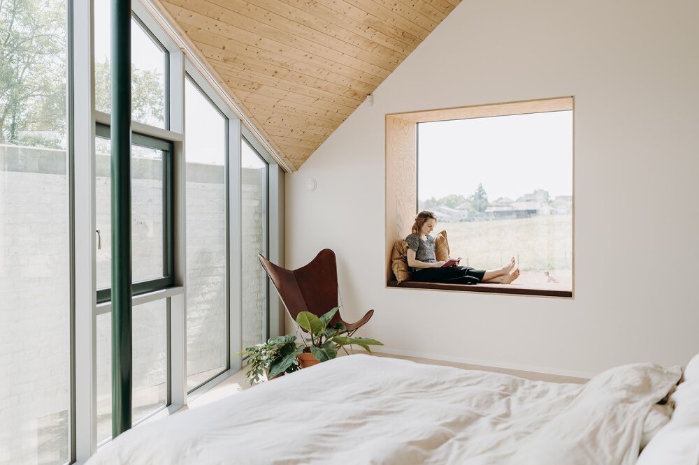 OYO architects carves triangular incision into farmhouse in rural belgium, bringing in light and air