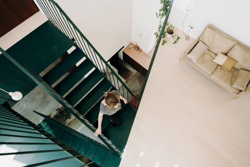 OYO architects carves triangular incision into farmhouse in rural belgium, bringing in light and air