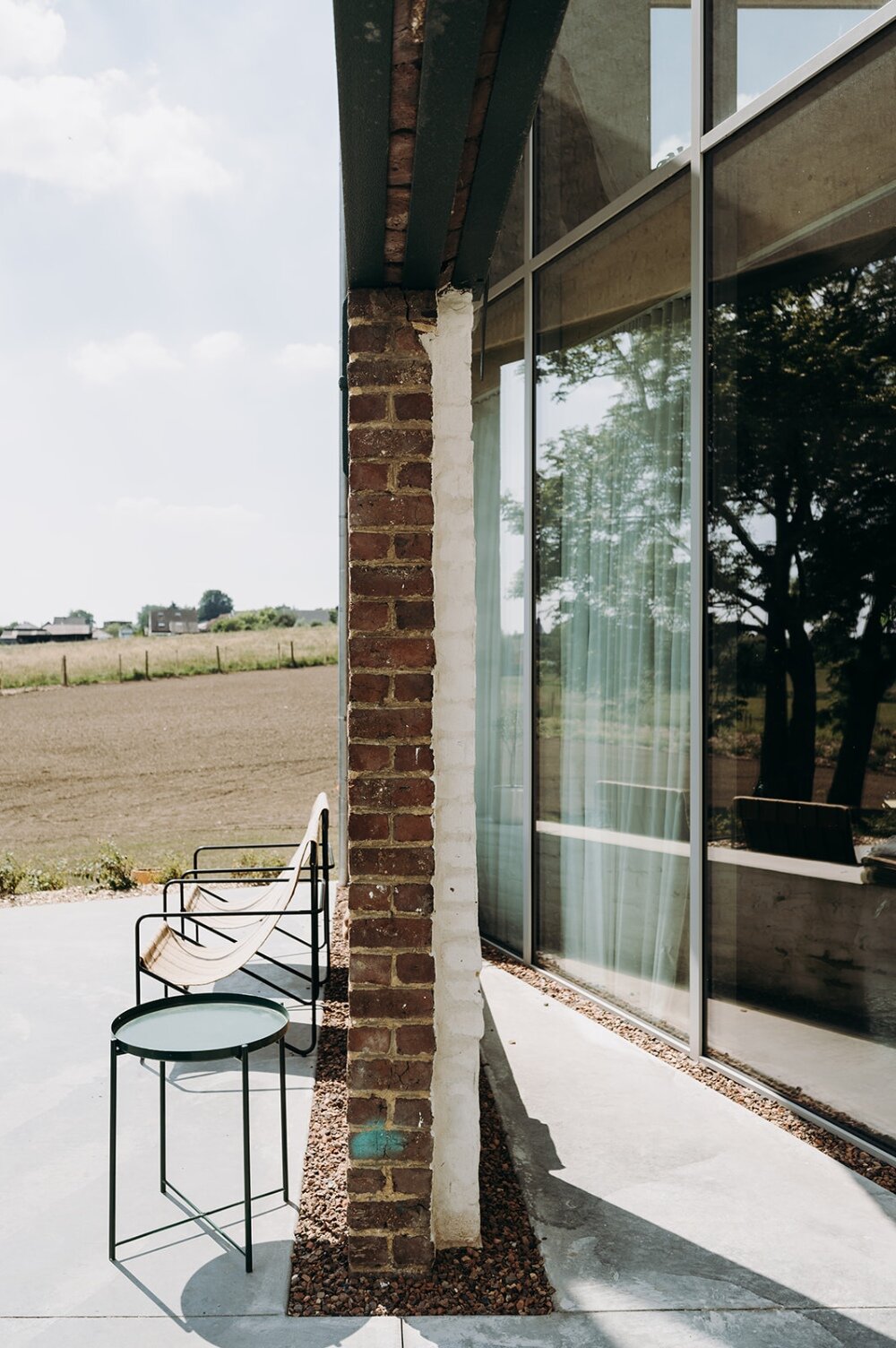 OYO architects carves triangular incision into belgium farmhouse to form luminous courtyard