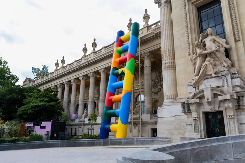 paola pivi leans 20-meter technicolor ladder against the grand palais in paris