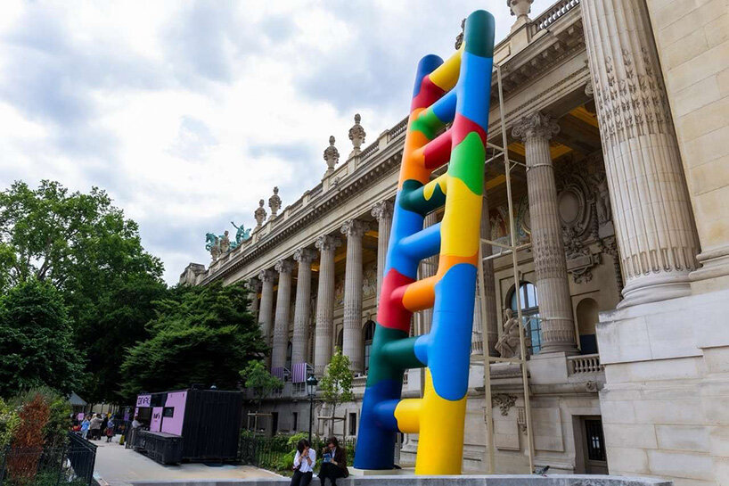paola pivi leans 20-meter technicolor ladder against the grand palais in paris