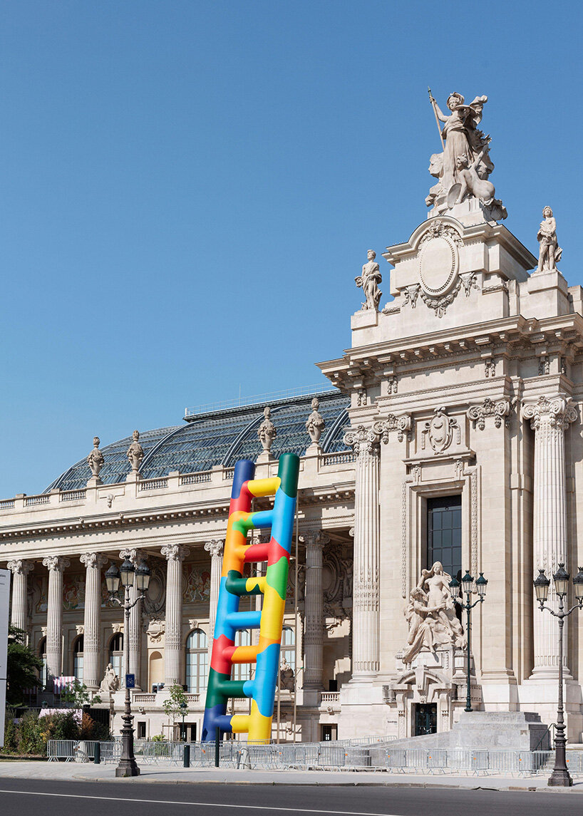 paola pivi leans 20-meter technicolor ladder against the grand palais in paris