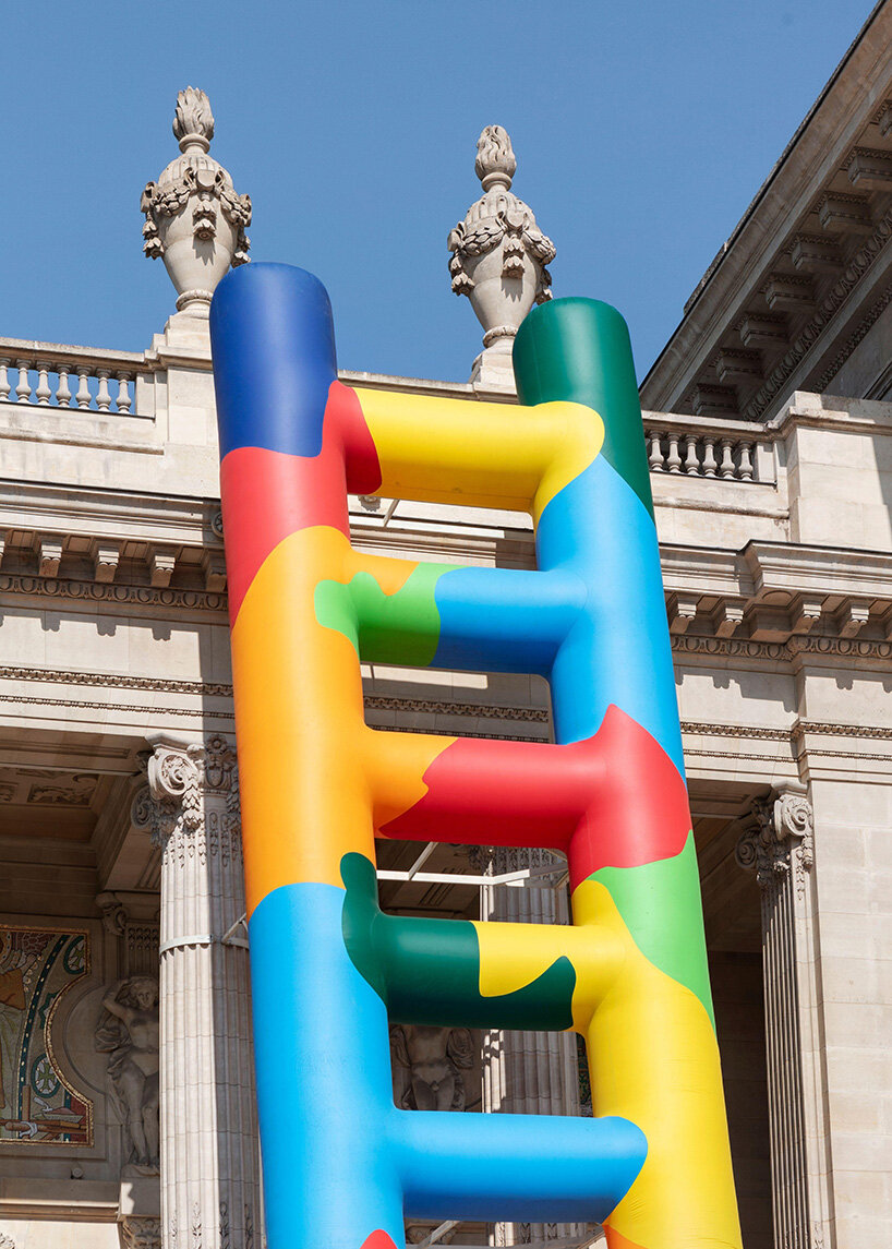 paola pivi leans 20-meter technicolor ladder against the grand palais in paris