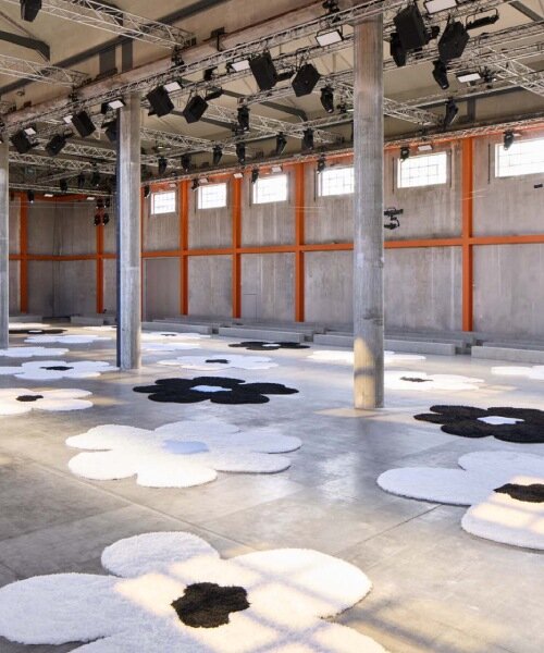 flower carpet islands by AMO bloom across prada's ss26 menswear showcase in milan