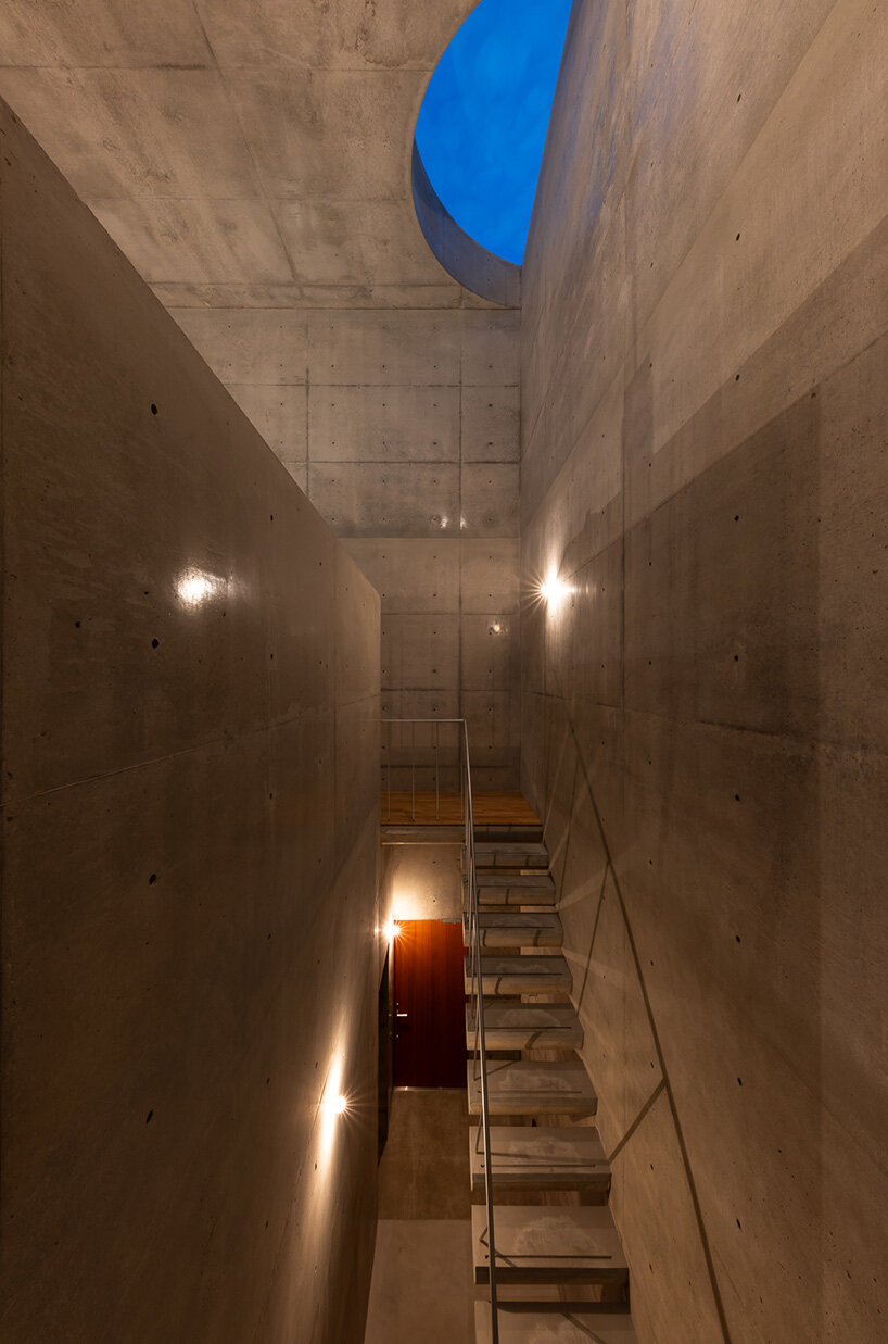 semicircular skylights cast sunbeams across takeshi hosaka's concrete residence in tokyo