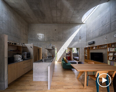semicircular skylights cast sunbeams across takeshi hosaka's concrete residence in tokyo