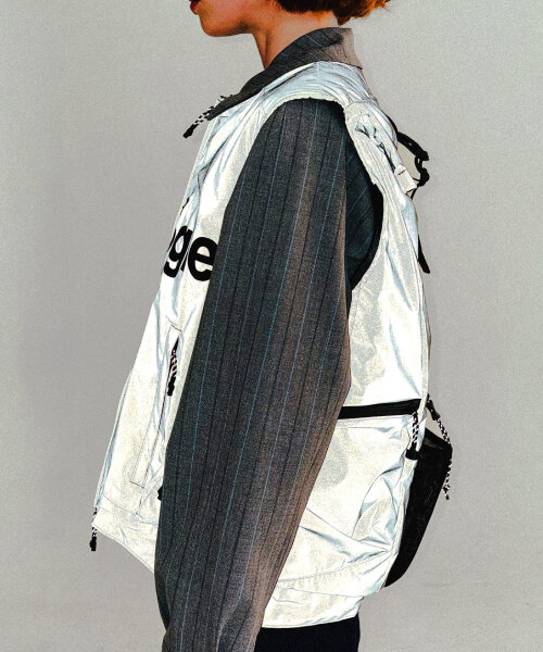 this backpack vest combines outerwear with storage to carry personal objects anywhere