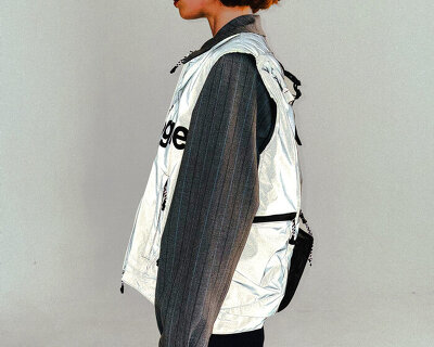 this backpack vest combines outerwear with storage to carry personal objects anywhere