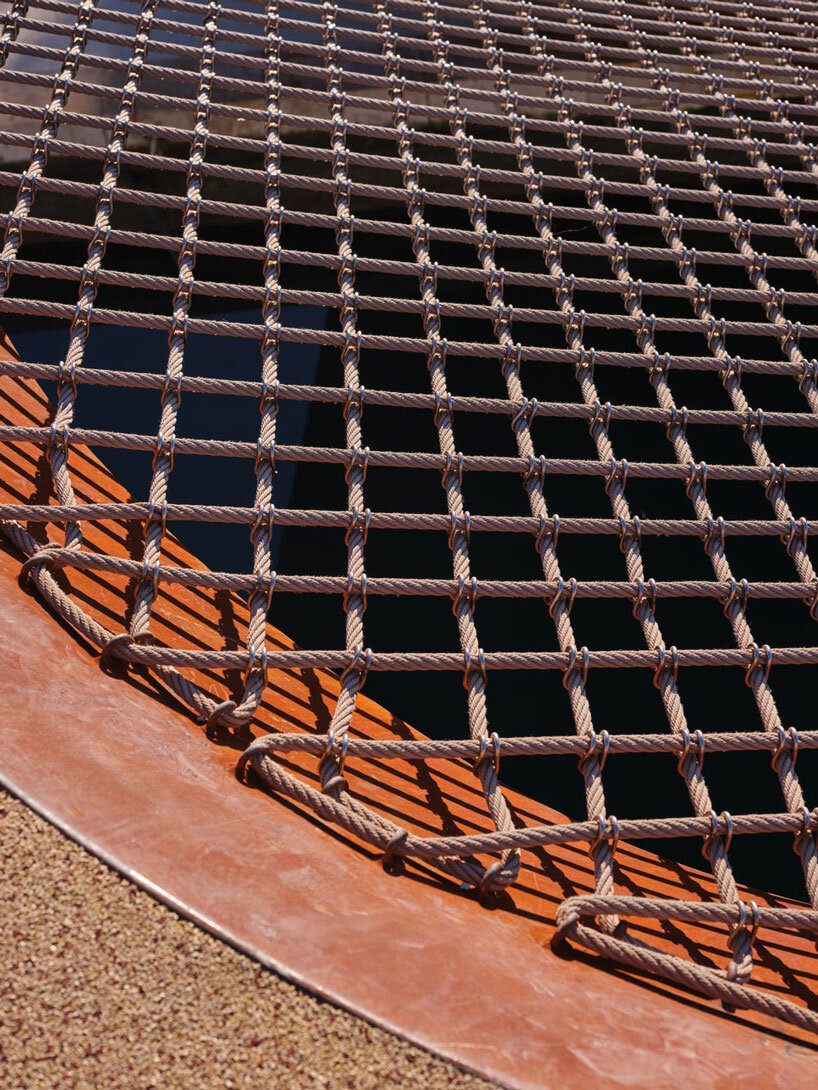 slender steel bridge with integrated net seating expands over foša port in croatia