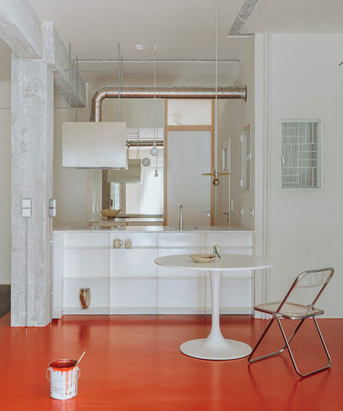 red floor runs over minimal 1970s athens apartment revamped by threshold