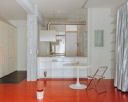 red floor runs over minimal 1970s athens apartment revamped by threshold