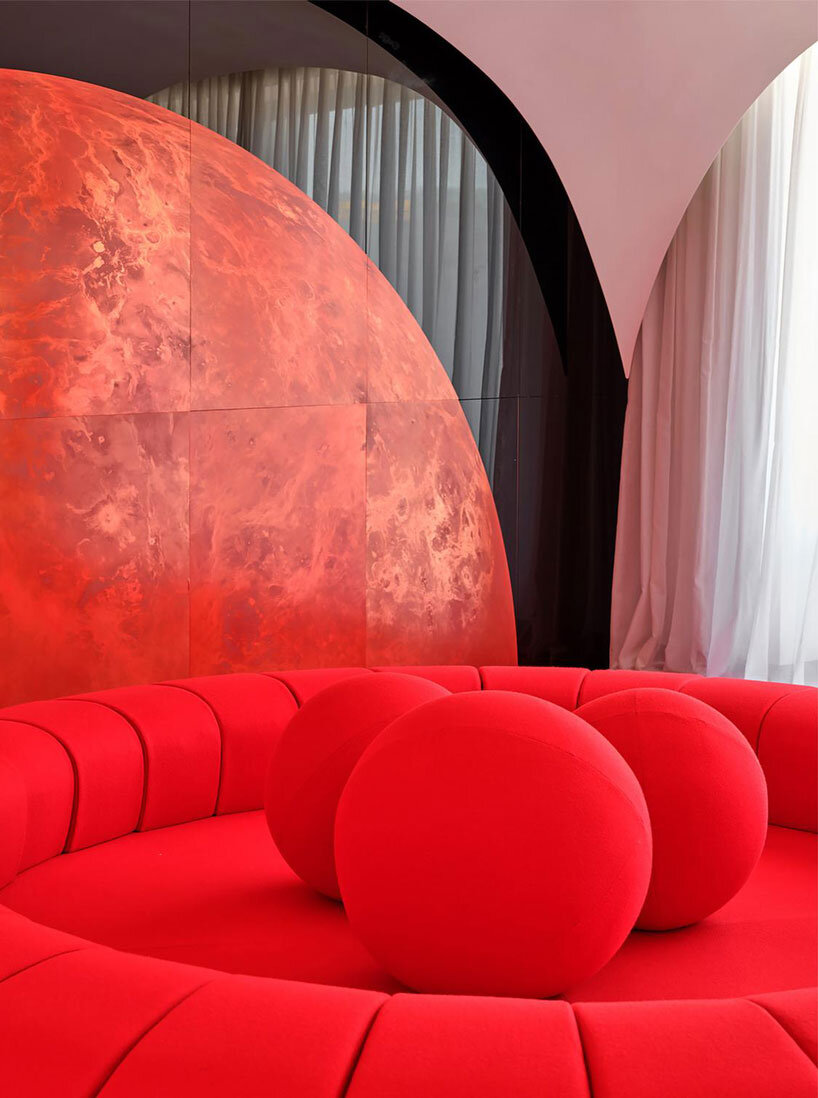 copper planet installation and red undulating seating anchor venus lounge by asap/ in beijing