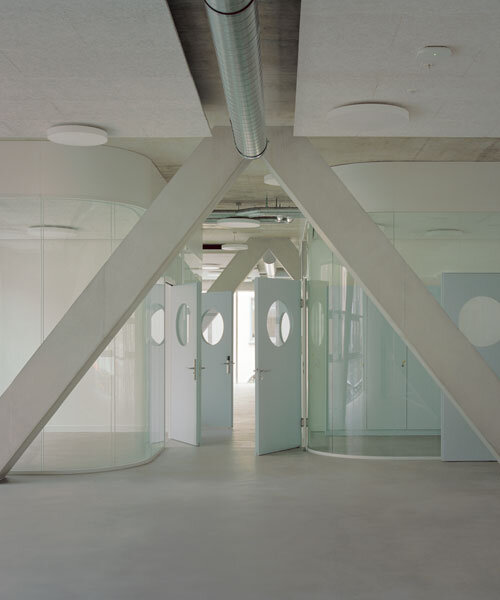 elevated concrete truss frame forms vocational school for construction trades in zurich