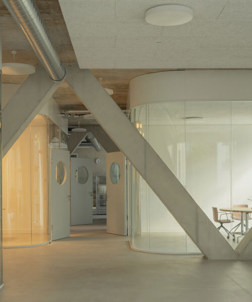 elevated concrete truss frame forms vocational school for construction trades in zurich