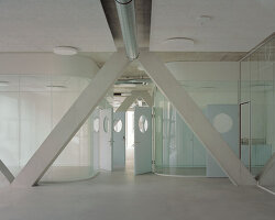 elevated concrete truss frame forms vocational school for construction trades in zurich