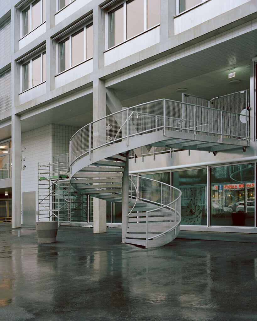 elevated concrete truss frame forms vocational school for construction trades in zurich