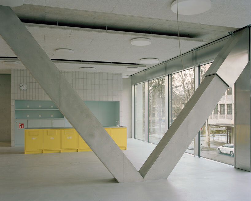 elevated concrete truss frame forms vocational school for construction trades in zurich