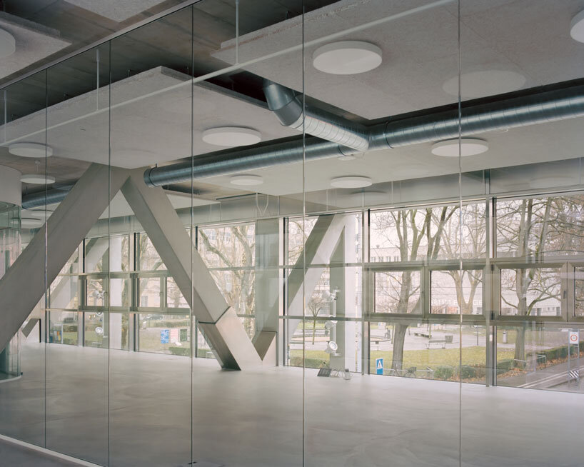 elevated concrete truss frame forms vocational school for construction trades in zurich