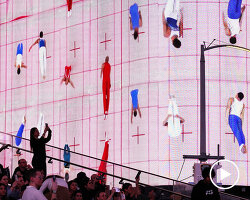 leaping olympic gymnasts form shifting colorfield in yuge zhou's NYC times square takeover