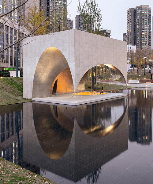 atelier xi unveils public art center as a landscape of four travertine pavilions in china