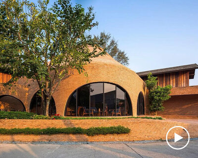 undulating brick facade wraps studio miti's athita pool villa and spa in thailand