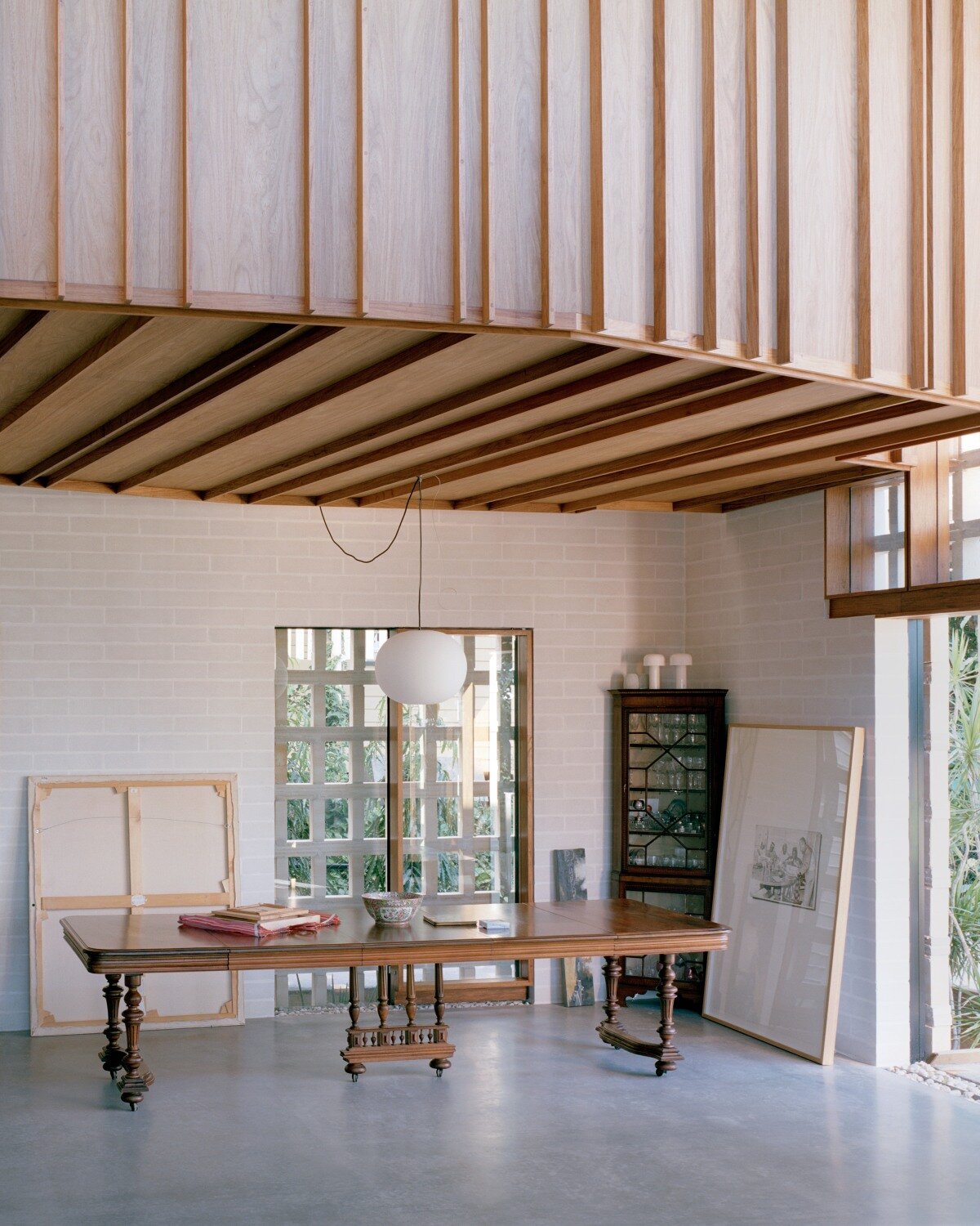 salvaged terracotta, bricks, and metal nets wrap around peter besley's australian house