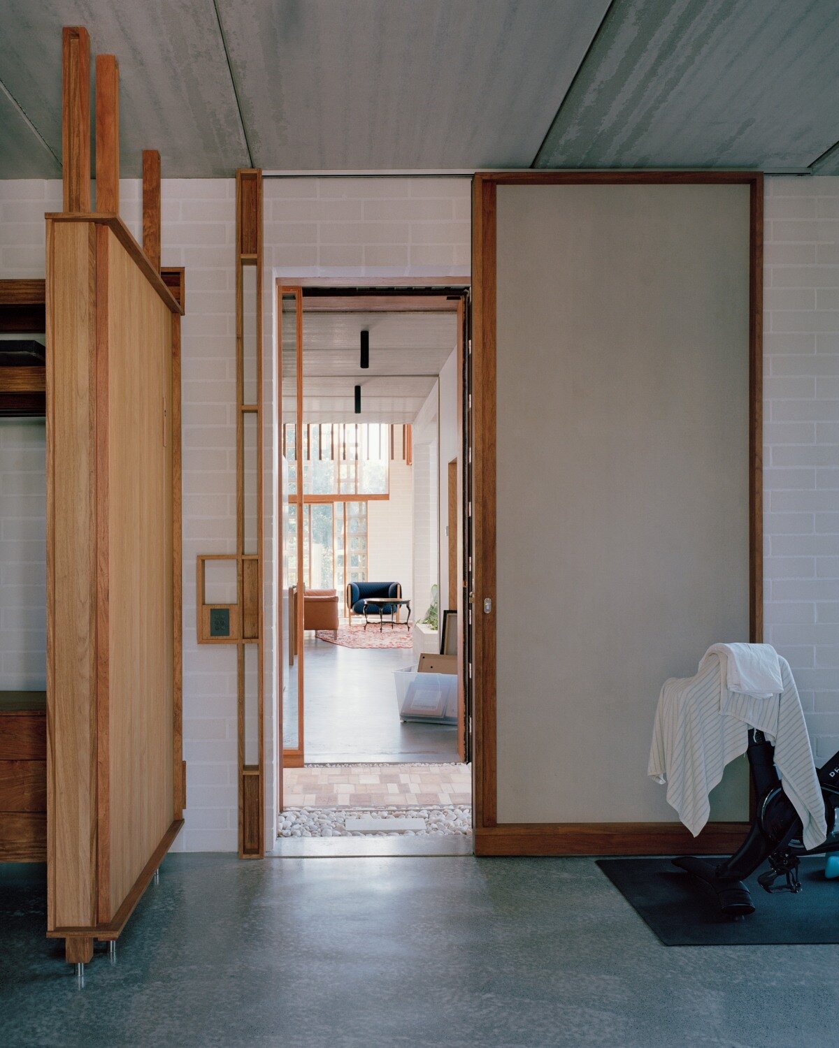 salvaged terracotta, bricks, and metal nets wrap around peter besley's australian house