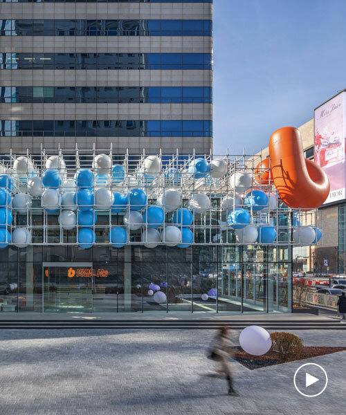 vibrant balloons nestle within metallic scaffolding atop seoul's playful urban hub by SSP