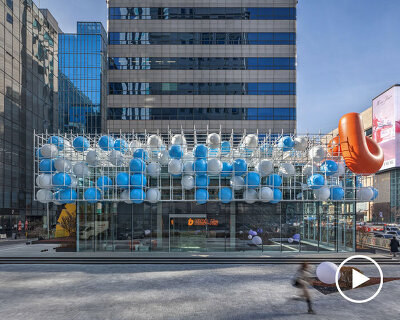 vibrant balloons nestle within metallic scaffolding atop seoul's playful urban hub by SSP