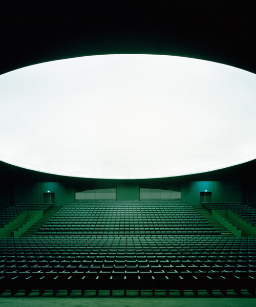 bofill taller carves elongated arches around deep green auditorium in morocco