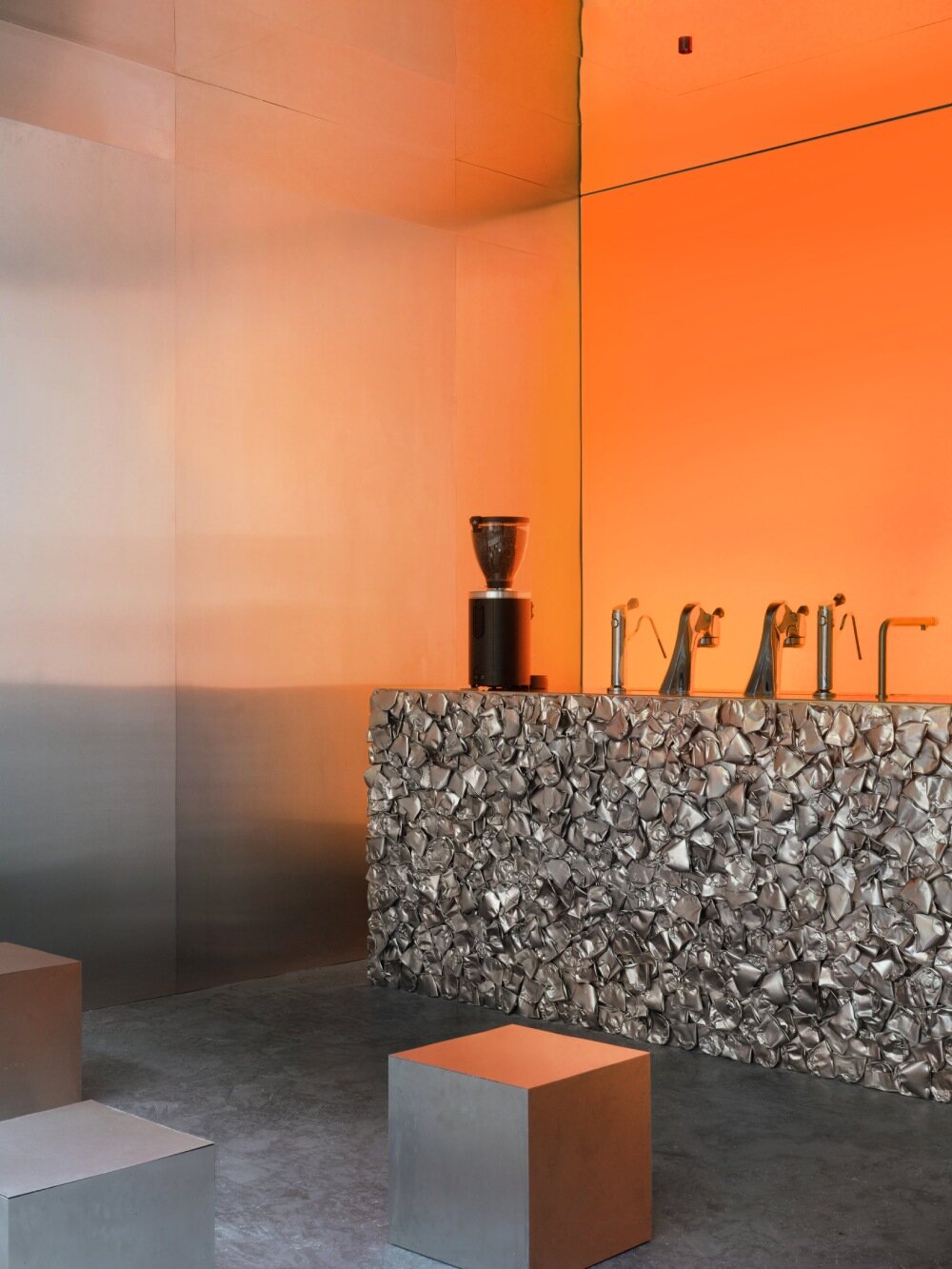 warm orange glow bathes crosby studios' chromatic café in paris 