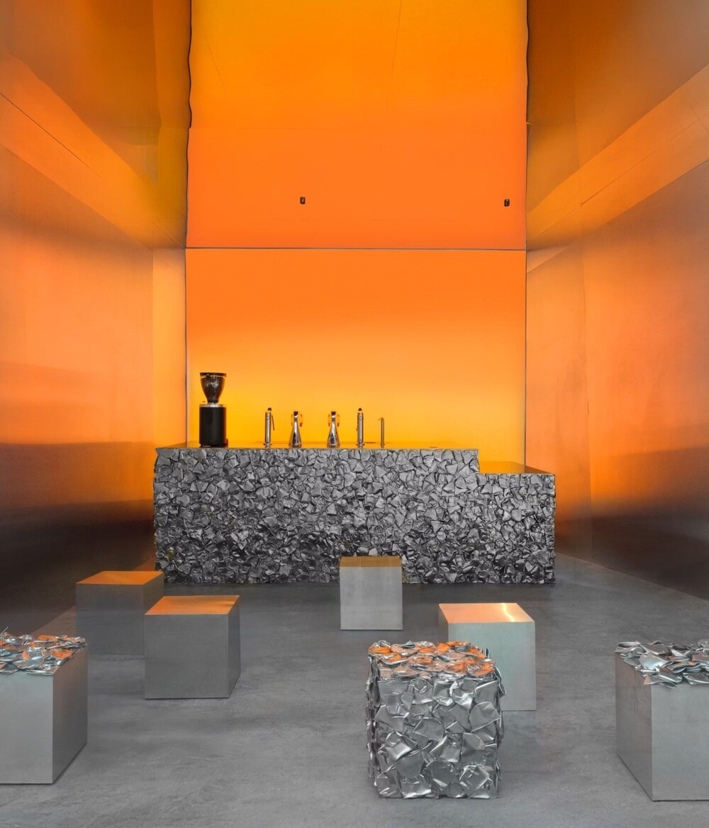 warm orange glow bathes crosby studios' chromatic café in paris 