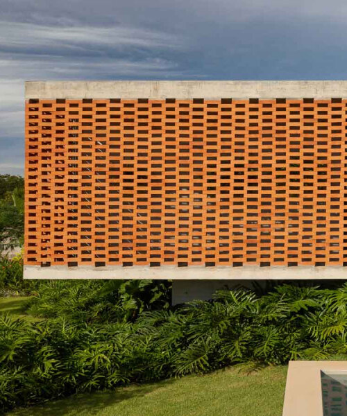 perforated brick facade punctuates fernanda padula’s concrete house in brazil