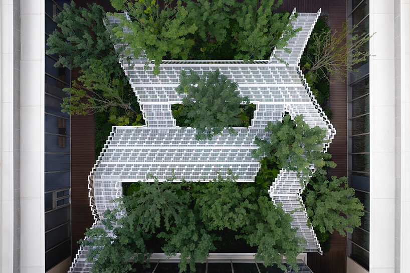 cascading staircase threads through sunken courtyard by TROP at shanghai residence