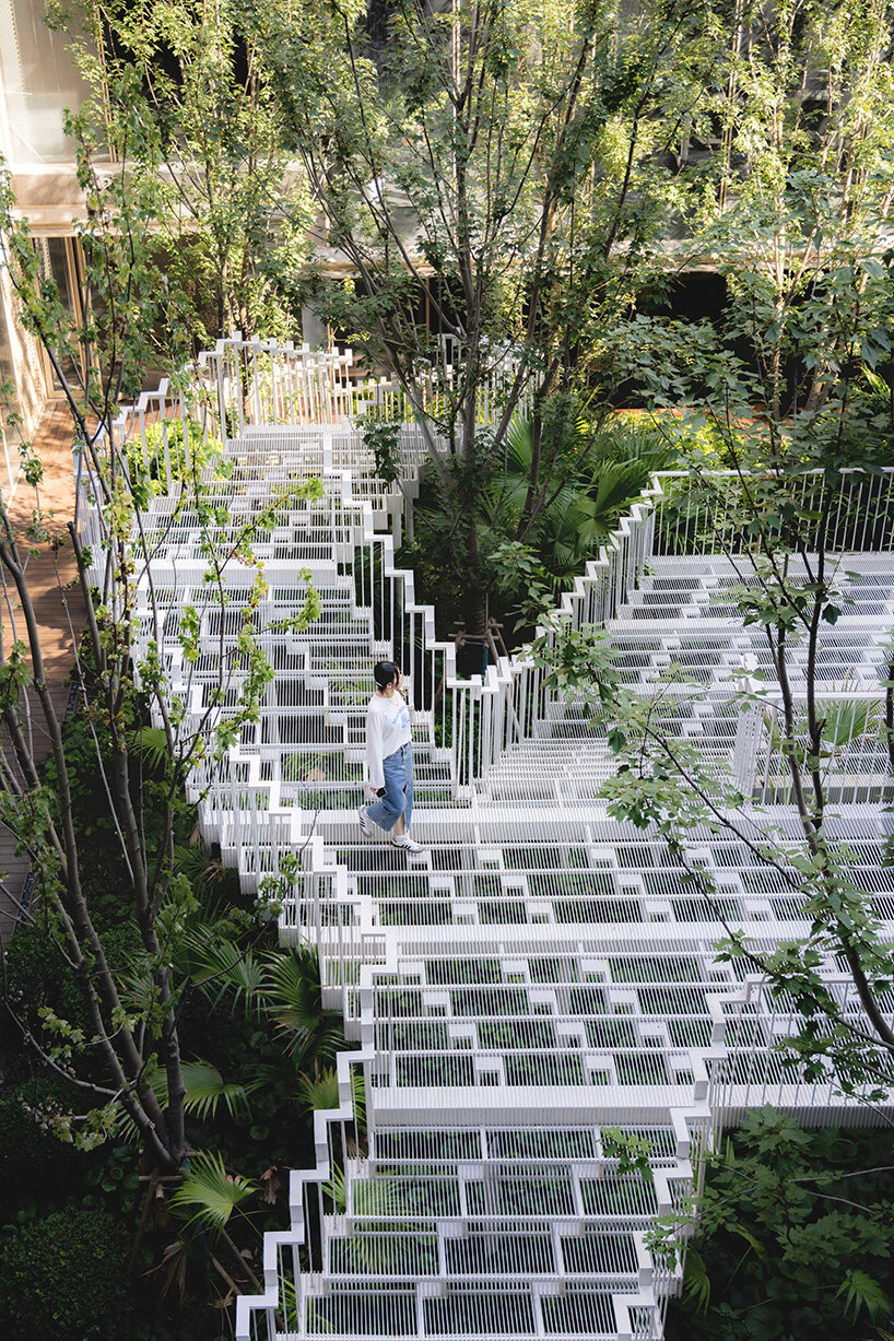 cascading staircase threads through sunken courtyard by TROP at shanghai residence