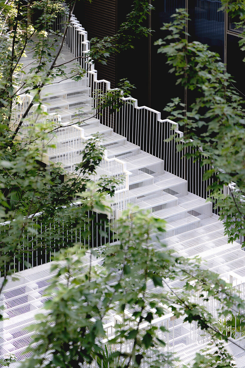 cascading staircase threads through sunken courtyard by TROP at shanghai residence