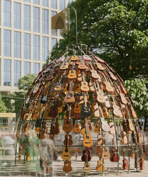 wind-powered sculpture turns donated guitars into sonic art installation in manchester