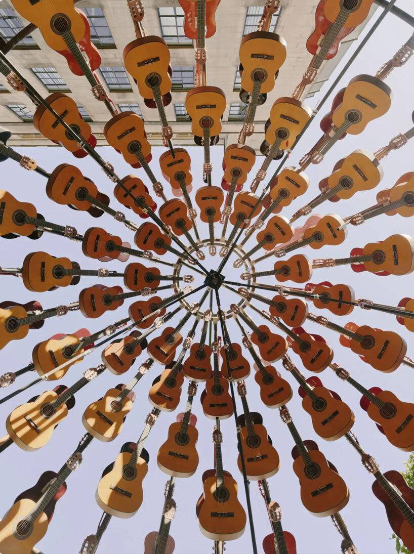 wind-powered sculpture turns donated guitars into sonic art installation in manchester