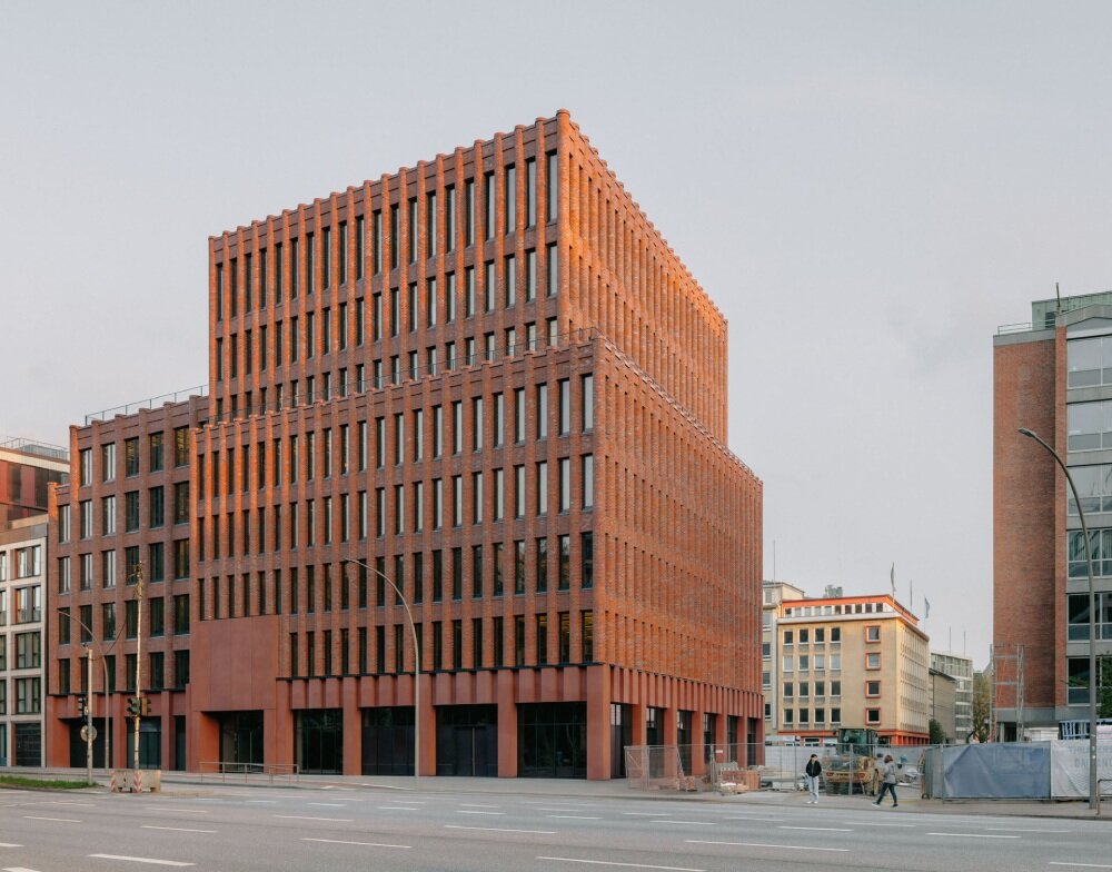 semi-circular brick columns clad christ & gantenbein's hamburg complex in rhythmic pattern