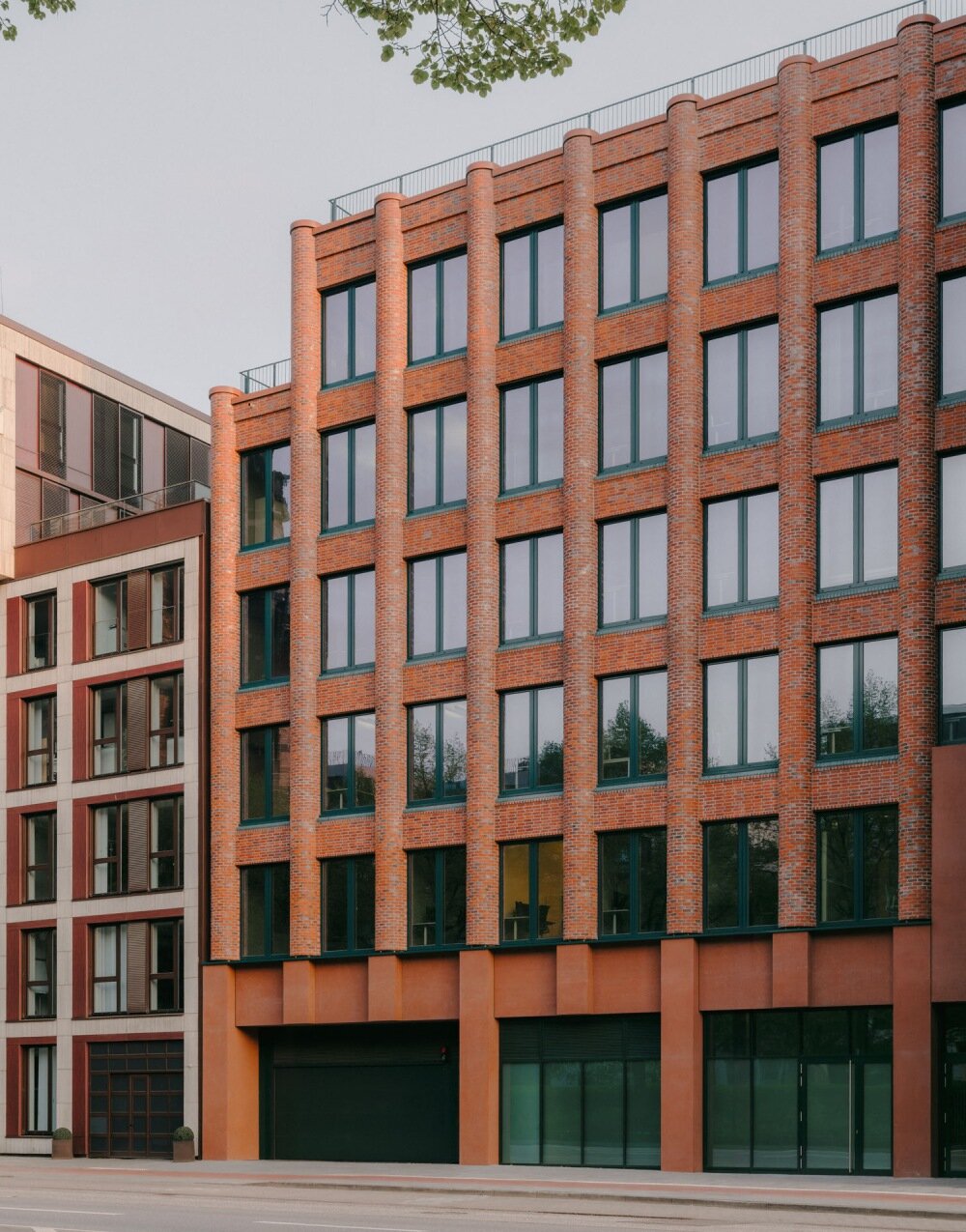 semi-circular red bricks clad christ & gantenbein's hamburg complex in rhythmic pattern