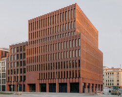 semi-circular brick columns clad christ & gantenbein's hamburg complex in rhythmic pattern
