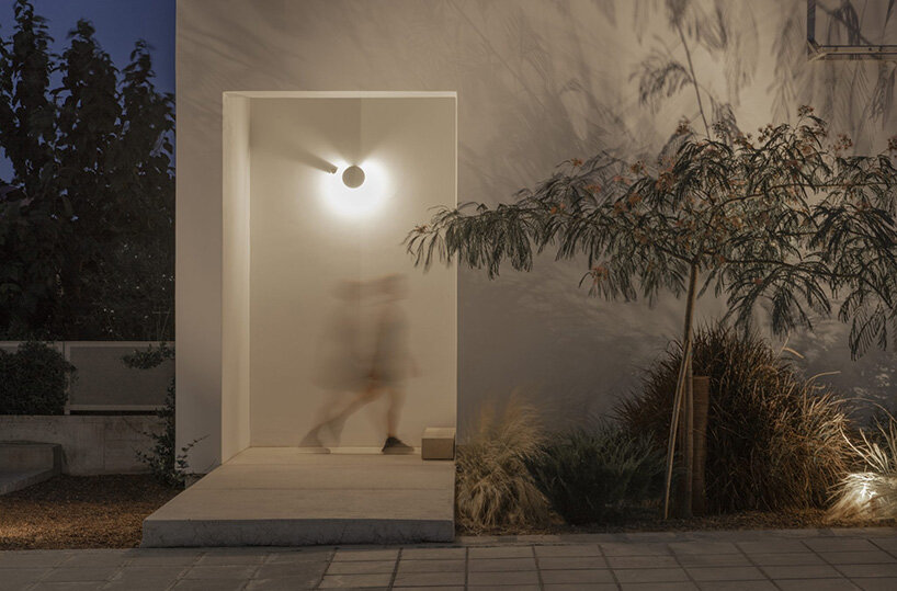 concentric white walls envelop garden-filled residence by draftworks* architects in cyprus