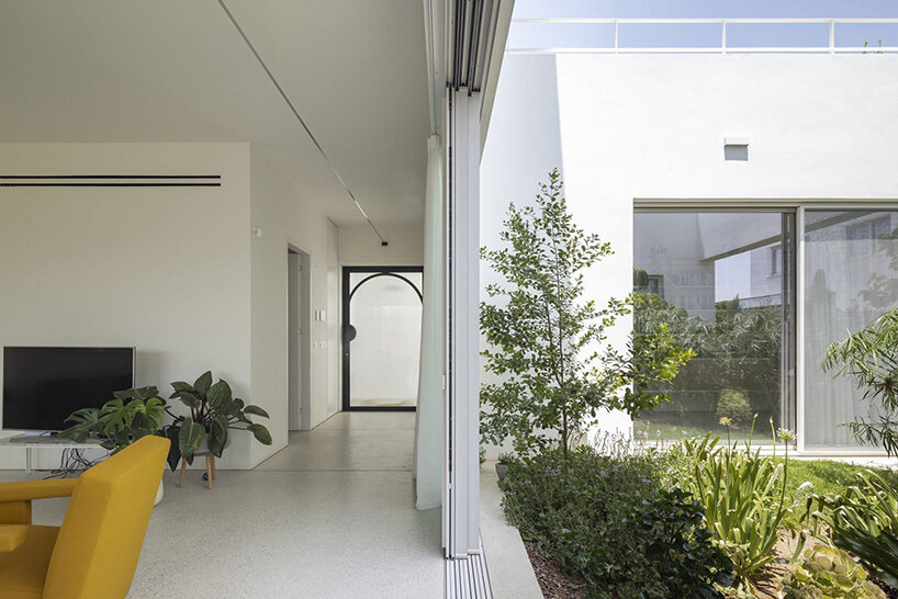concentric white walls envelop garden-filled residence by draftworks* architects in cyprus