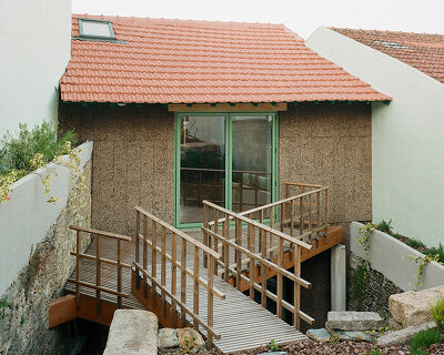 cork-clad house in portugal gets upside-down layout through atelier local's redesign