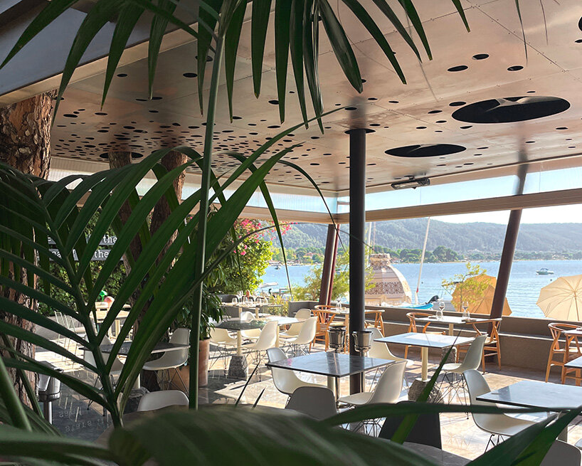 CTRLZAK channels filtered forest light in pine-inspired restaurant at ekies resort, greece