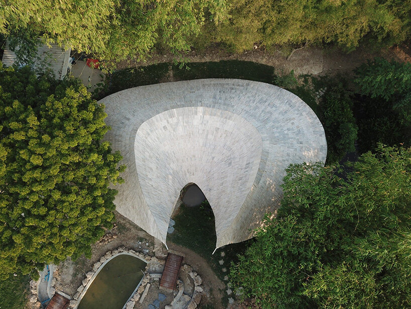 curved edges rise to form bull-like bamboo pavilion by chiangmai life architects in thailand