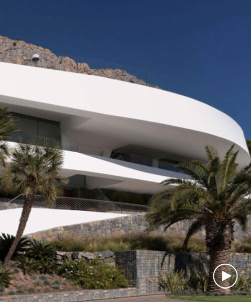 curved house's sinuous facade traces mountainous terrain in spain